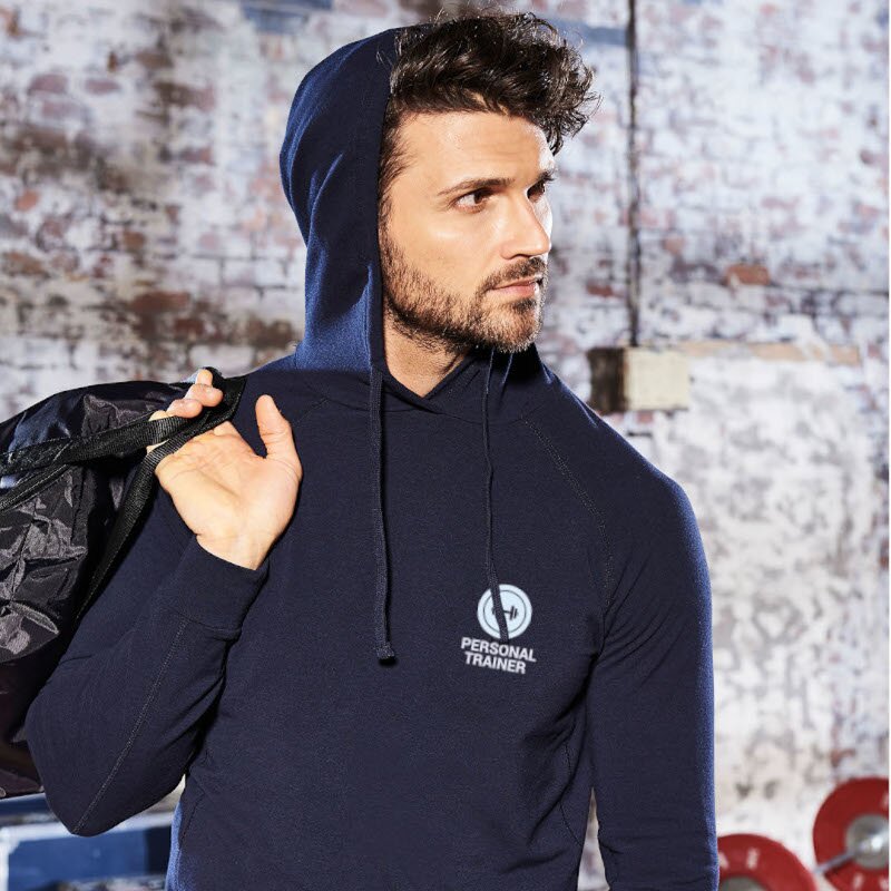 Male trainer in gym wearing navy blue personalised hoodie