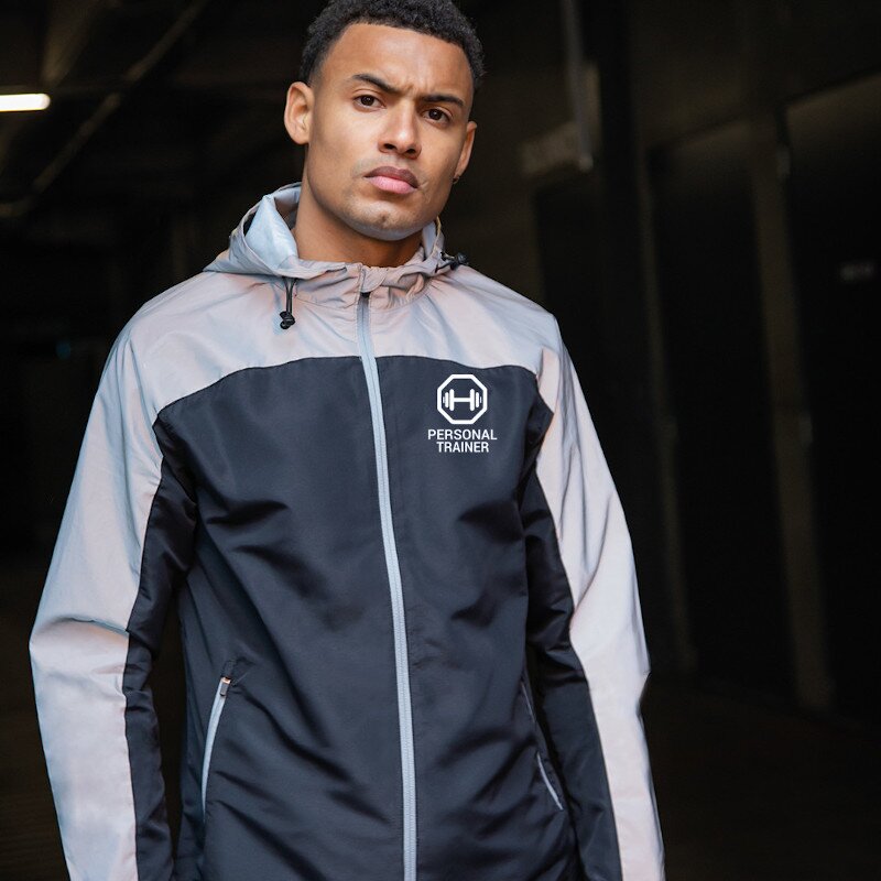 Male PT wearing showerproof grey and black personal trainer jacket